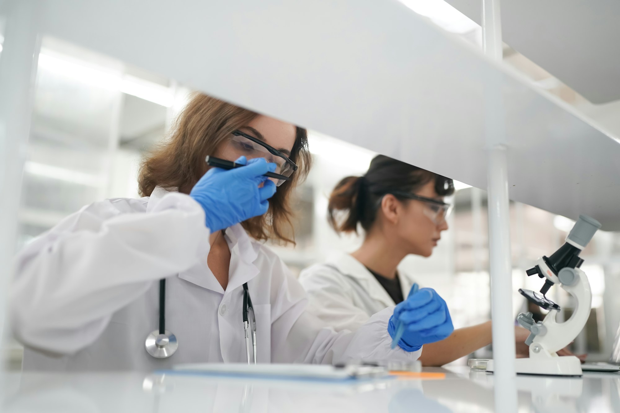 Medic working with microscope at the laboratory