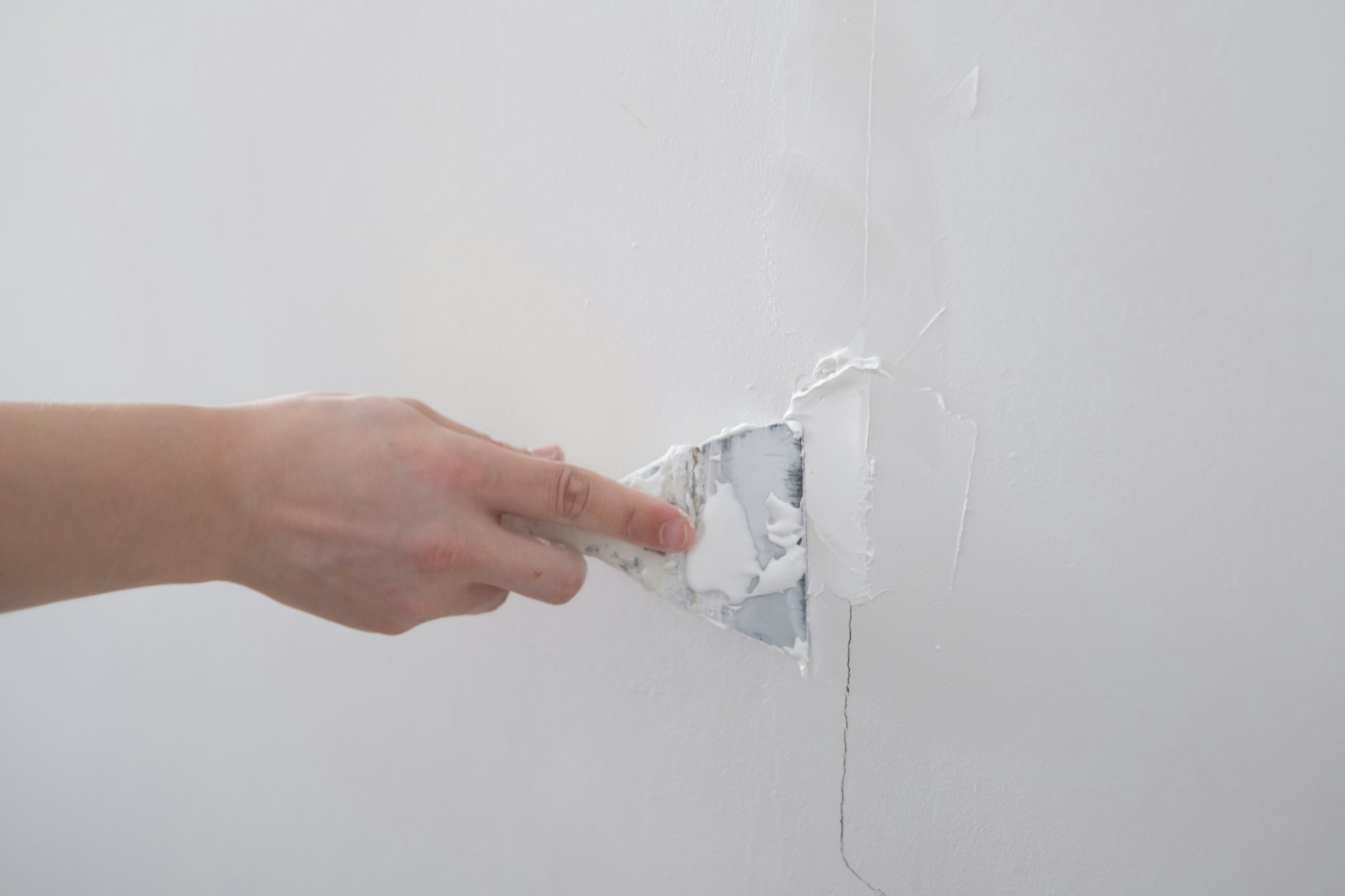 repairing walls with putty and spatula