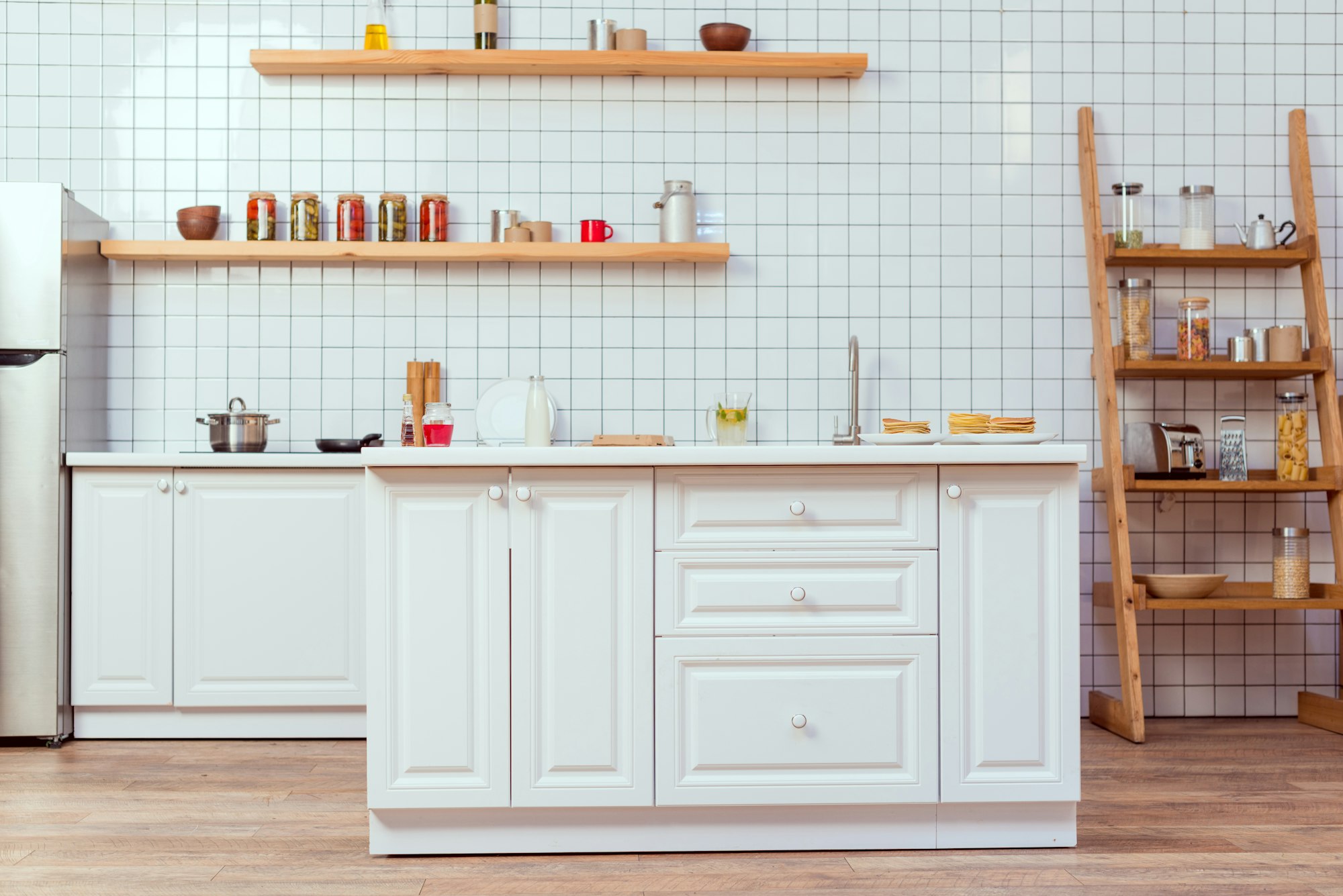 modern kitchen design with white furniture and tile on background